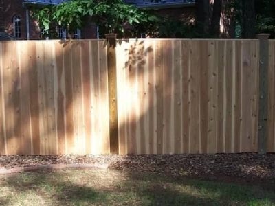 Solid Board Fence with a Cap Board and Wood Post Caps